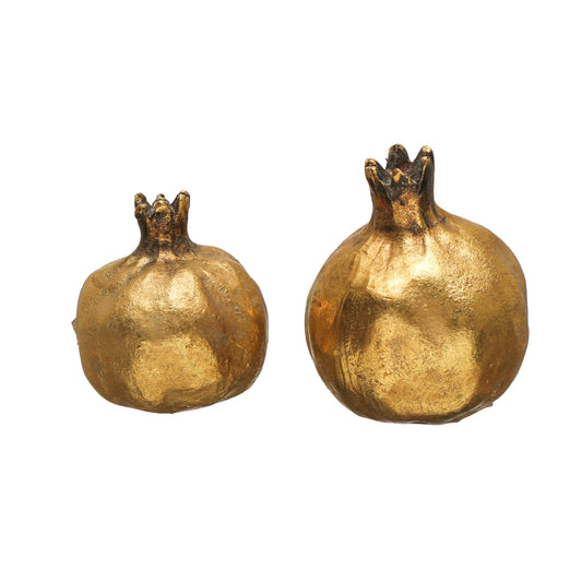 gold pomegranate-shaped objects on a white background