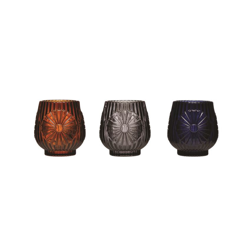 The 2-3/4" Round x 3"H Pressed Glass Tealight/Votive Holder make the perfect gift or subtle statement to any décor. Comes in 3 Colors; Amber, Grey, or Black.