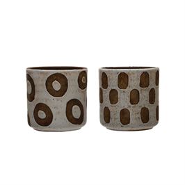 These Terra-cotta Planter w/ Shapes patterns in a White Distressed Finish Holds a 4" Pot.  The two patterns are a donut shape pattern and a thumb print shape pattern.