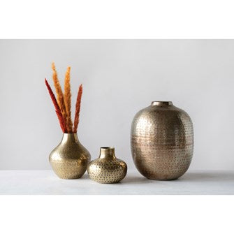 Add some Mid-Century to your room or shelf with this 5-1/2" Round x 5-3/4"H Hammered Metal Vase with an Antique Brass Finish. 