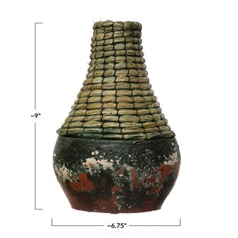 These Distressed Black, Hand-Woven Rattan & Clay Vase are perfect for any coffee table or table arrangement. Add your favorite botanical to complete your style. (Each One Will Vary) Small: 6-3/4" Round x 9"H Large: 8-1/2" Round x 11-3/4"H